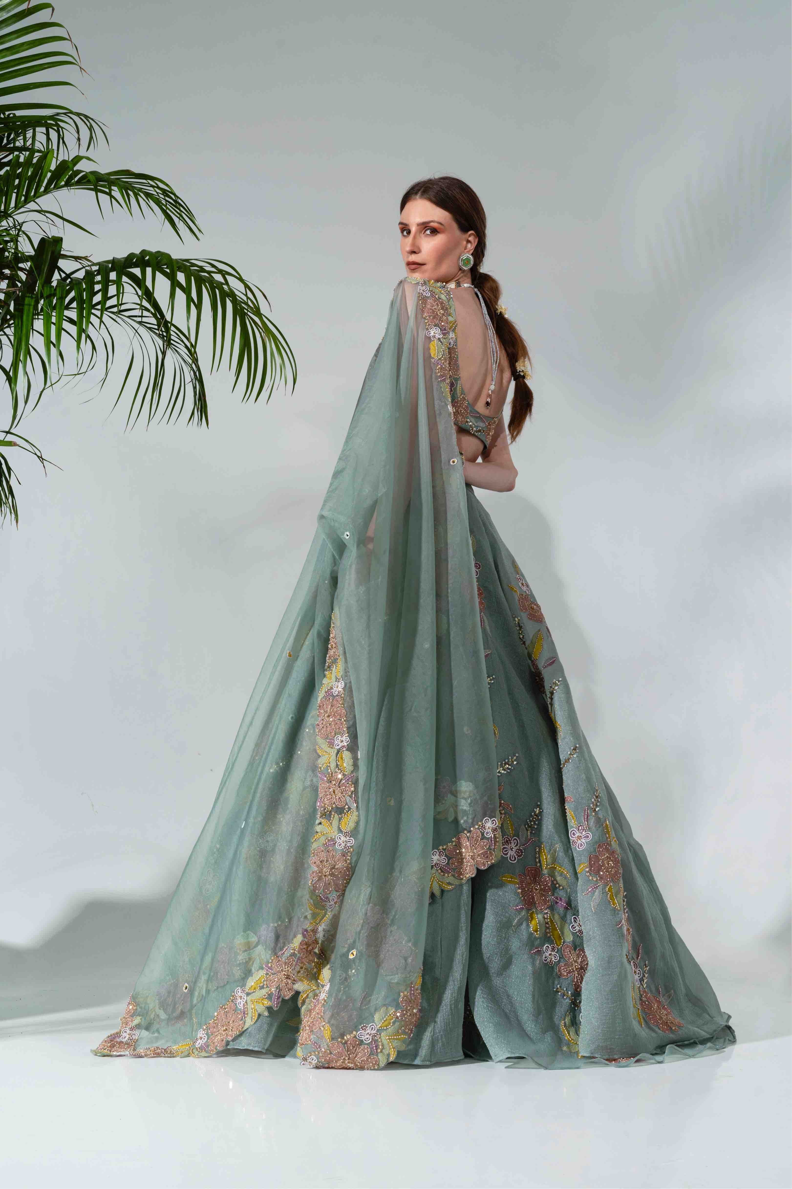 Dusty green lehenga featuring floral applique patterns