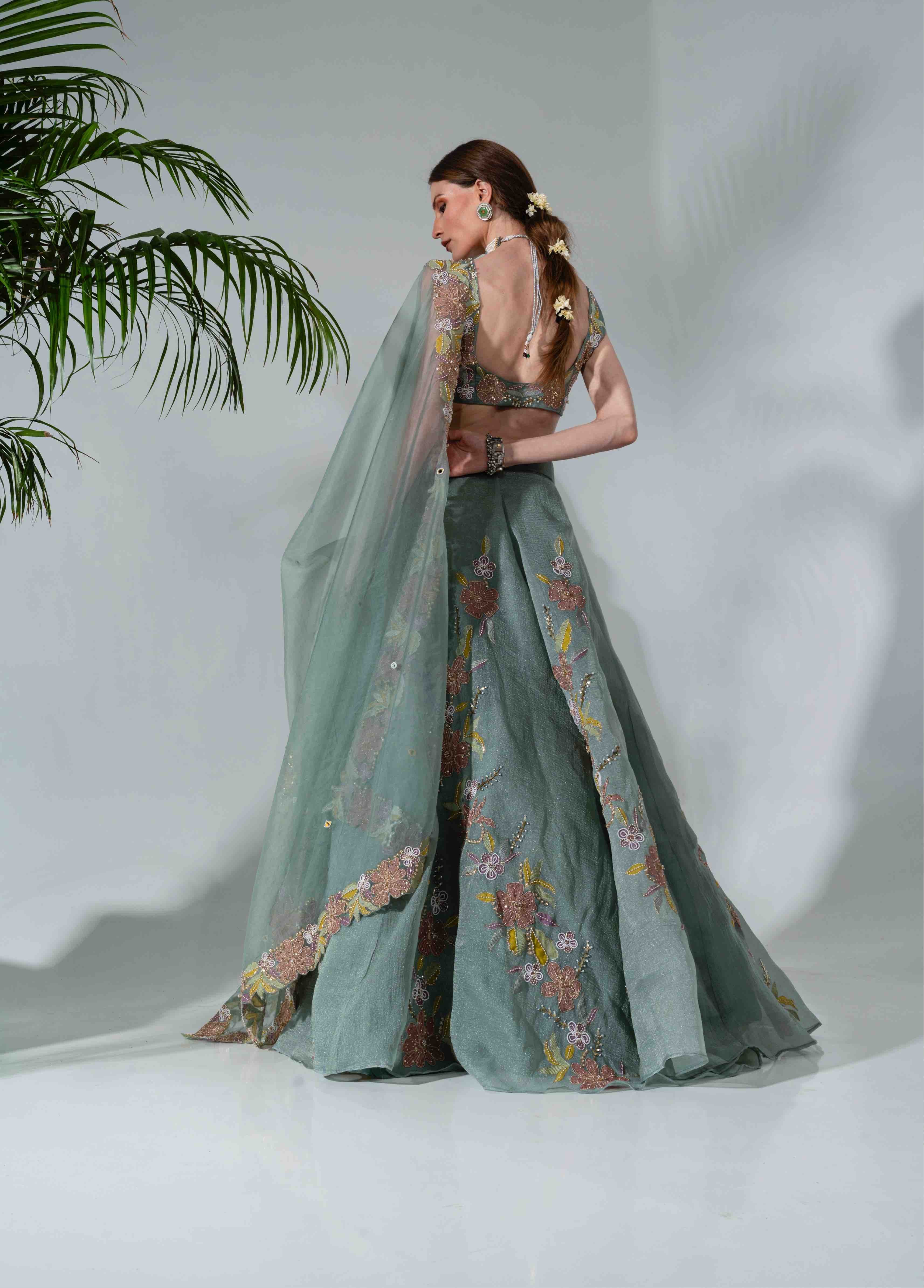 Dusty green lehenga featuring floral applique patterns