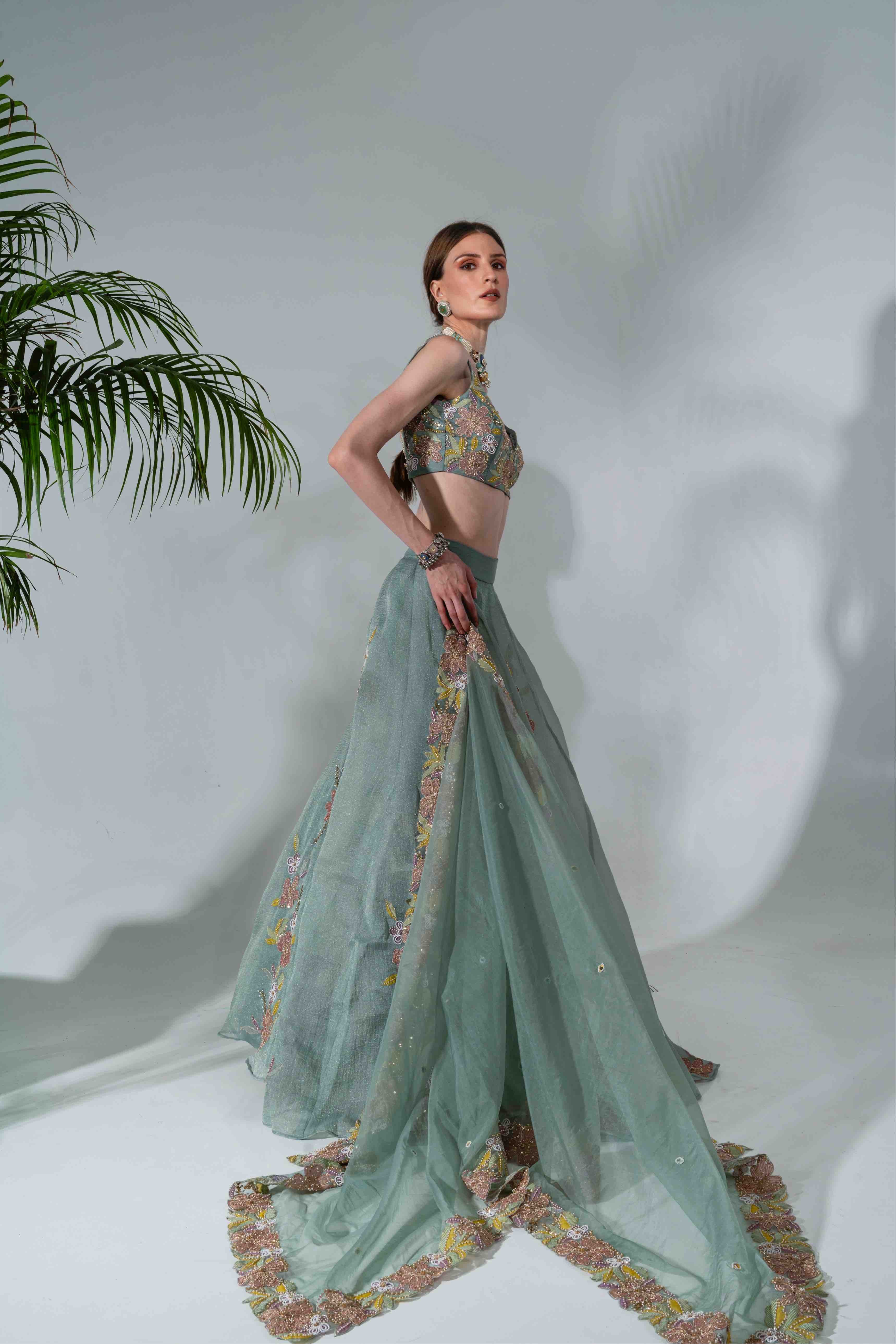 Dusty green lehenga featuring floral applique patterns