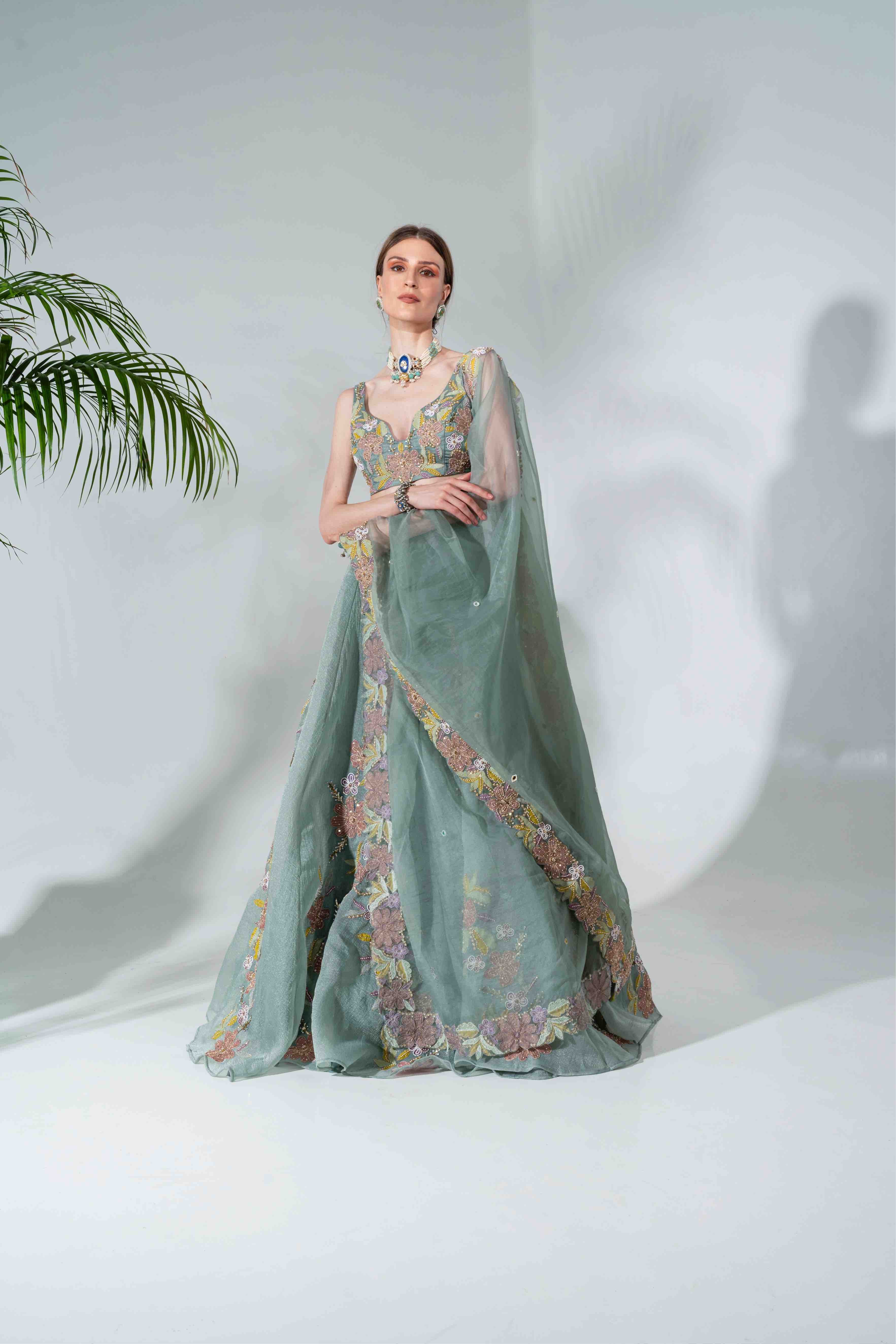 Dusty green lehenga featuring floral applique patterns