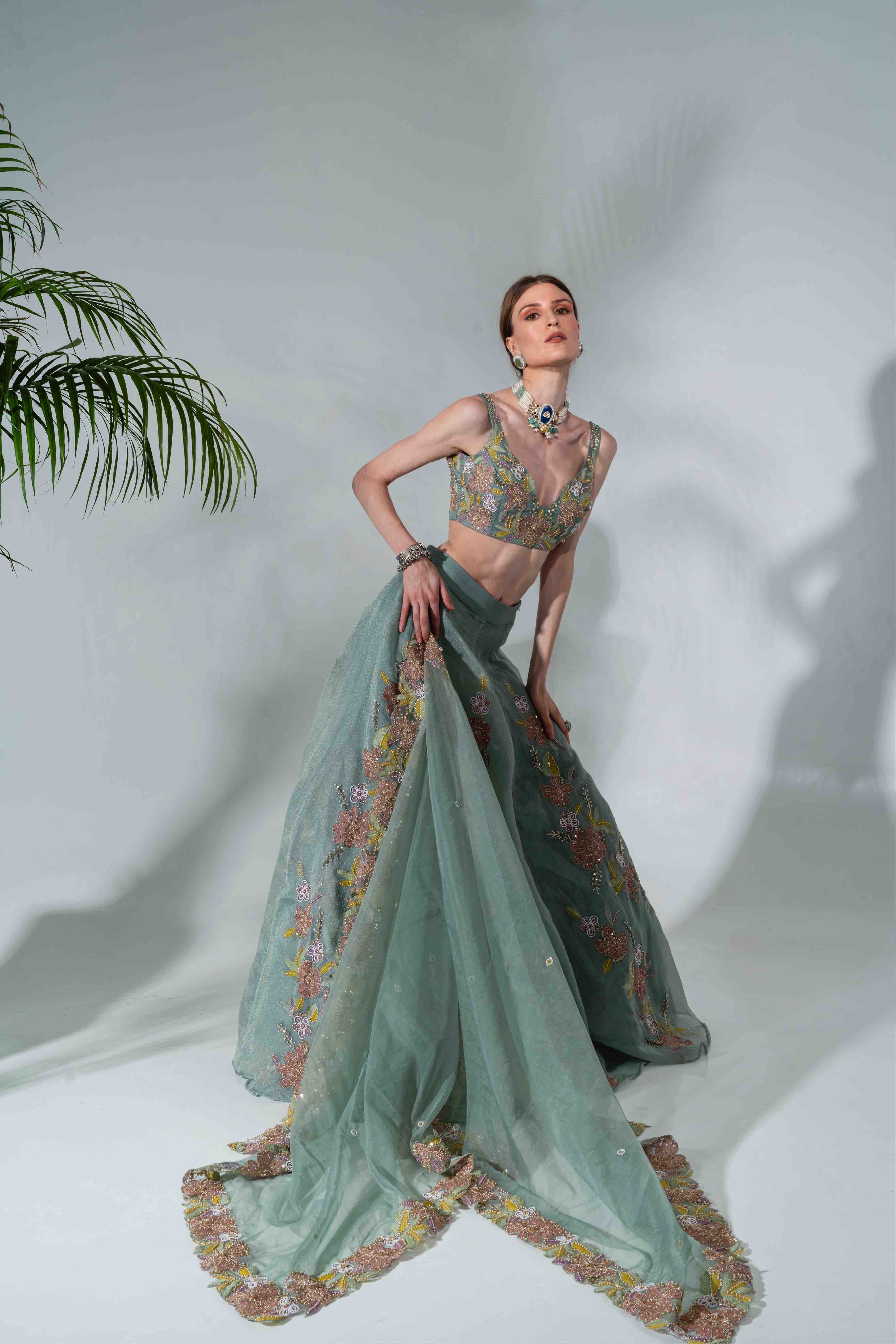 Dusty green lehenga featuring floral applique patterns