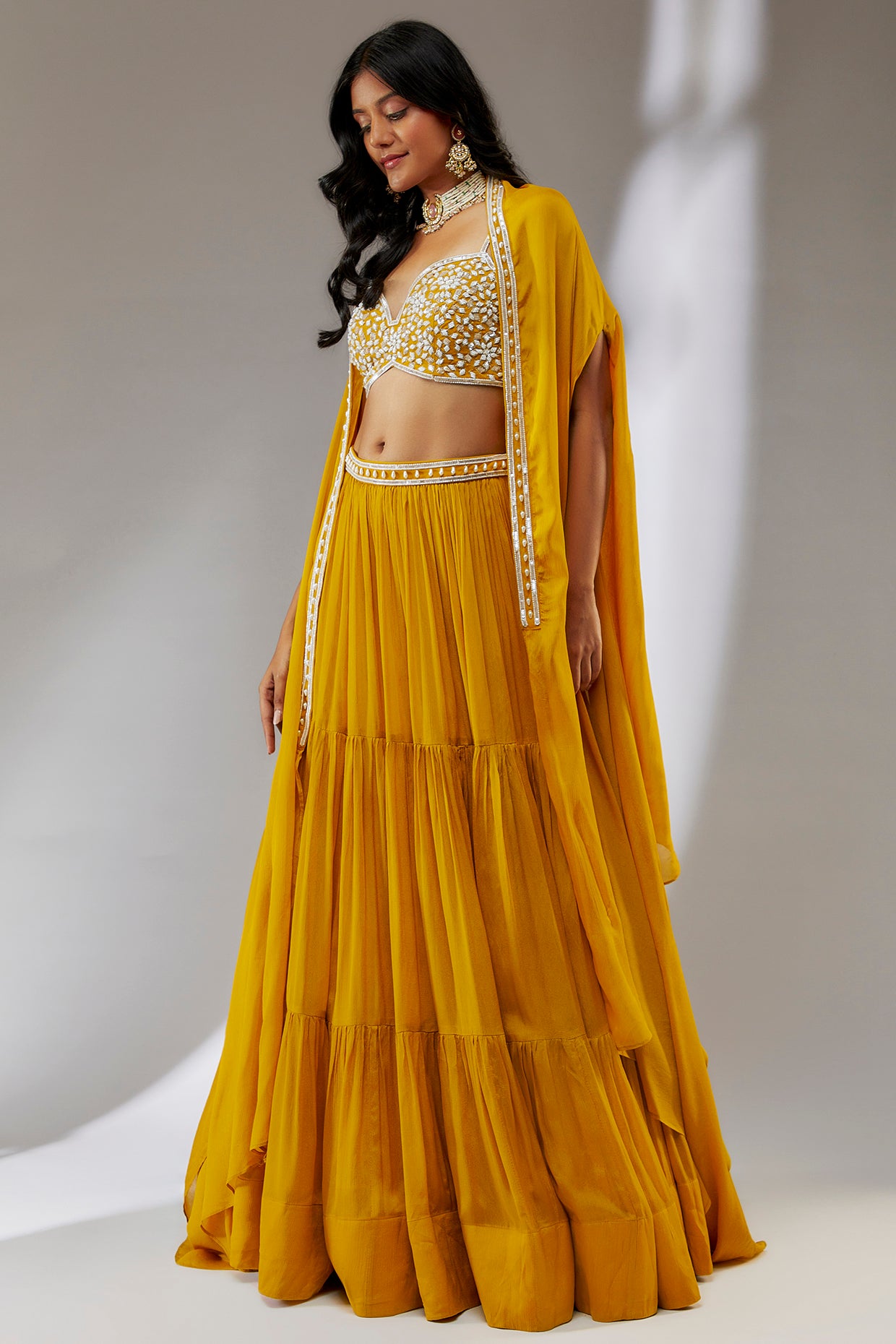 Yellow hand embroidered chiffon cape lehenga set